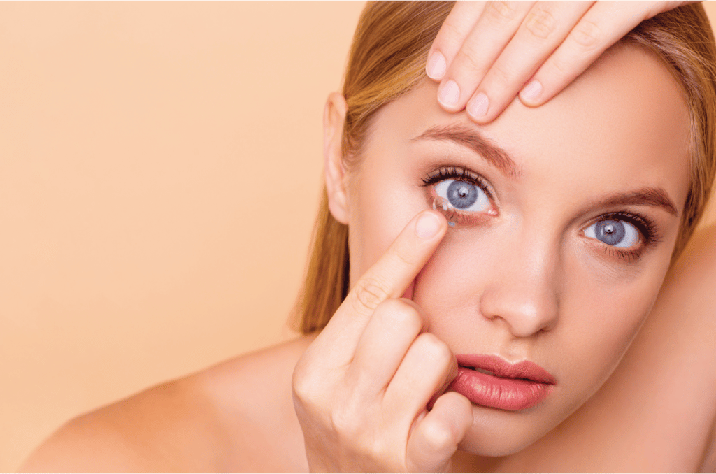 lady inserting a contact lens